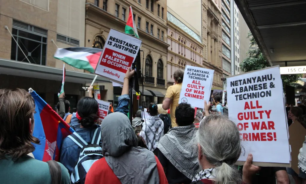 Protestors hold up placards across the road from Technion’s 100-year dinner event at the Great Synagogue, Sydney