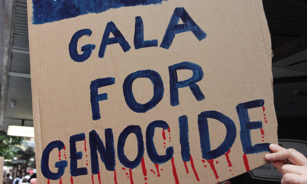 A protest sign reads: Gala for genocide