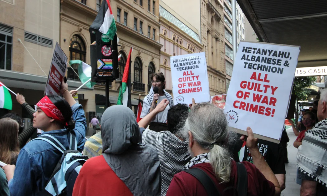 Protestors hold up placards outside the Technion event in Sydney