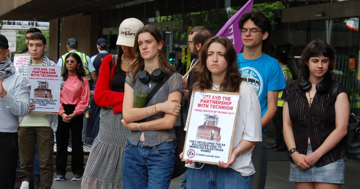 Protestors hold placards outside UTS 